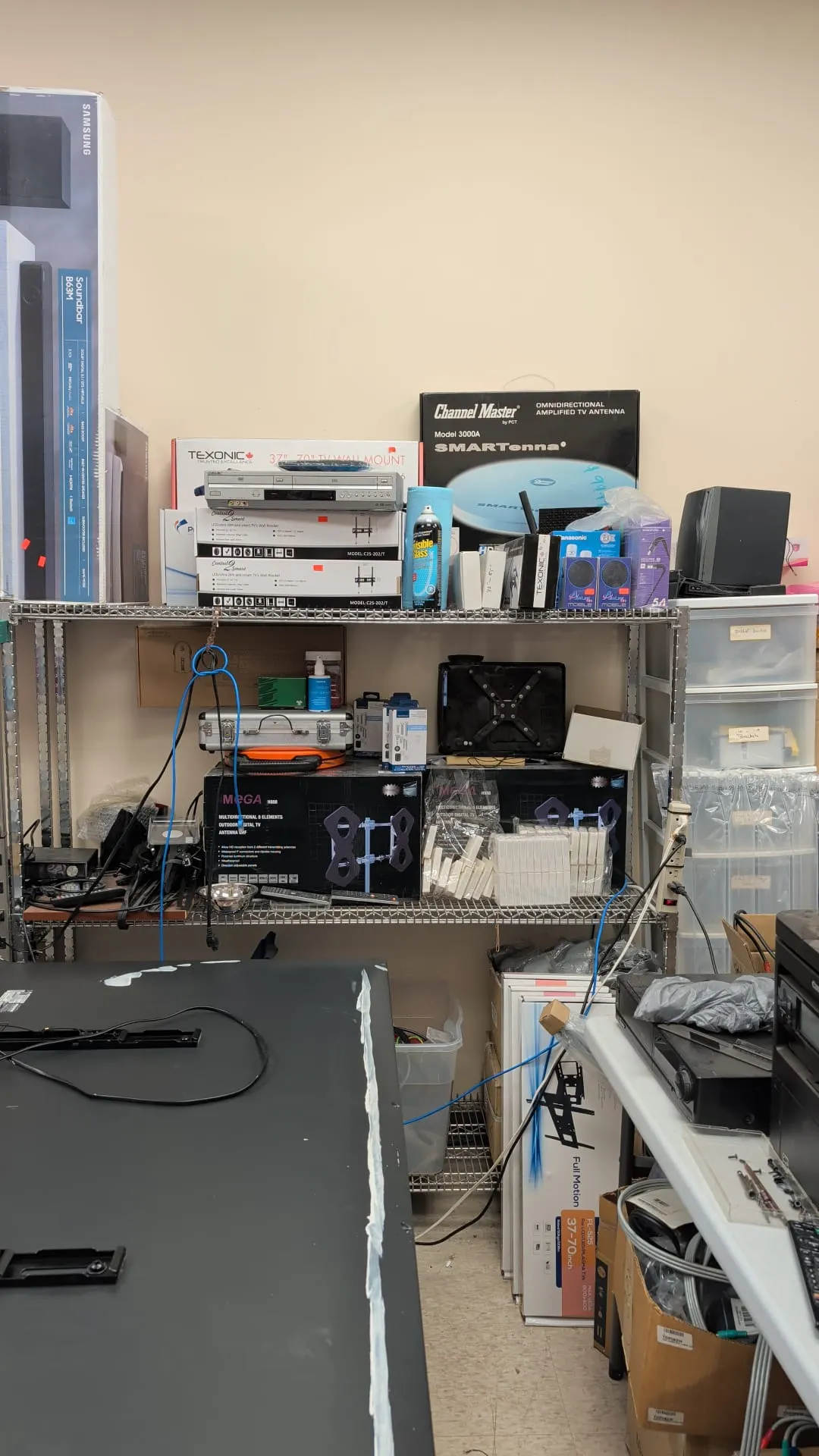 Shelves stocked with TV antennas, satellite receivers and antenna boxes